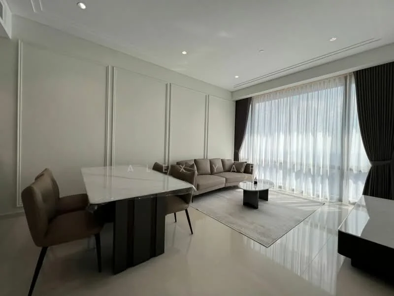 Living features: cream painted walls, white ceiling with recessed downlights, large floor-to-ceiling windows with sheer curtains, 3-seater fabric sofa in beige, coffee table, area rug with geometric pattern, dining table with 4 upholstered chairs, polished ceramic tile flooring, wall-mounted TV console, decorative wall paneling; style: modern; view: city.