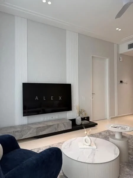 Living features: light grey painted walls, white ceiling with recessed downlights, floor-to-ceiling TV console, black flat-screen TV, marble TV stand, round white coffee table, grey area rug, blue fabric armchair, decorative vase on coffee table, minimalist decor, white door, wall-mounted intercom panel; style: modern.