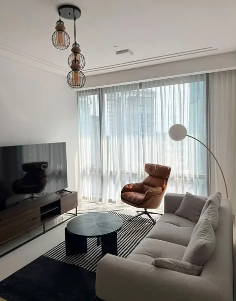 Living features: 3-seater fabric sofa in light grey, round black coffee table, wooden TV console, wall-mounted TV, floor lamp with curved arm, accent chair in brown leather, sheer curtains, recessed ceiling lights, striped area rug, white painted walls, large windows, open layout; style: modern.