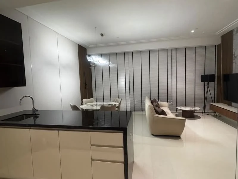 Living features: cream fabric sofa, round coffee table, wall-mounted TV, TV console, recessed downlights, floor-to-ceiling windows with blinds, decorative wall paneling, area rug, dining table with chairs, kitchen island with black countertop, white cabinetry; style: modern.