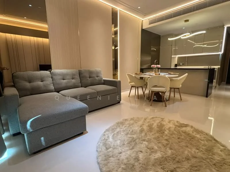 Living features: 3-seater fabric sofa in grey, area rug with fluffy texture, dining table with 4 white chairs, pendant lighting, recessed LED downlights, wall-mounted TV, cream painted walls, glossy tile flooring, open-plan layout, decorative wall paneling, floor-to-ceiling windows; style: modern.