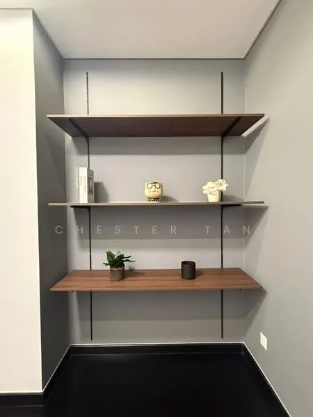 Room features: floating wooden shelves, grey painted walls, black flooring, decorative plant, decorative object, small black candle, book on shelf, white flower arrangement; style: modern.