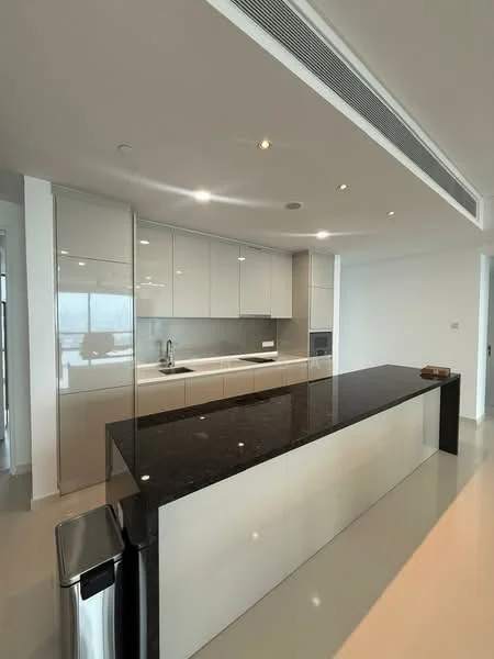 Kitchen features: black granite countertop, white glossy cabinetry, built-in oven, stainless-steel fridge, single-bowl stainless-steel sink, chrome pull-down faucet, ceramic tile flooring, recessed downlights, glass backsplash, island with seating, microwave, open shelving; style: modern.