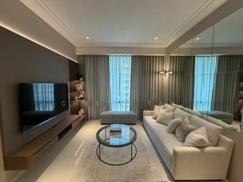 Living features: light grey fabric sofa with multiple cushions, round glass coffee table, wall-mounted TV, wooden TV console, floor-to-ceiling windows with sheer curtains, recessed lighting, decorative wall sconces, neutral wall colour, mirrored wall panel, area rug with subtle pattern, light-coloured flooring; style: modern; view: city.