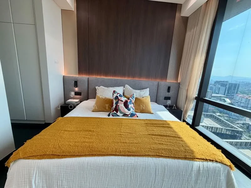 Bedroom features: king-size bed, upholstered headboard, decorative throw pillows, yellow throw blanket, bedside lamps, floor-to-ceiling windows, curtains, wood panel accent wall, built-in wardrobe, carpet flooring, city view; style: modern; view: city.