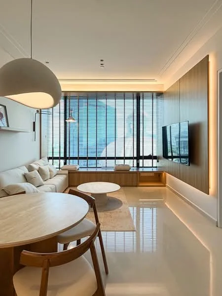 Living features: cream fabric sectional sofa, wooden coffee table, round dining table, wooden dining chairs, wall-mounted TV, built-in cabinetry, floor-to-ceiling windows, roller blinds, recessed LED downlights, pendant light, polished tile flooring, decorative wall paneling, area rug; style: modern; view: city.
