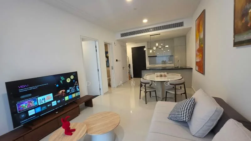 Living features: light grey fabric sofa, round coffee table, TV console, wall-mounted TV, decorative artwork on wall, white walls, recessed downlights, floor-to-ceiling windows, open-plan layout to dining area, polished tile flooring; style: modern. Dining features: round dining table, upholstered dining chairs, pendant lighting above table, open kitchen layout, white cabinetry, black countertop; style: modern.