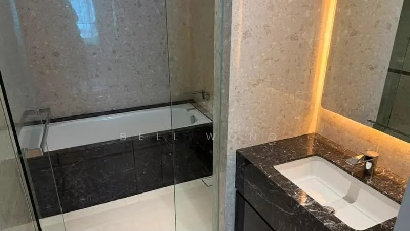 Bathroom features: freestanding bathtub, glass shower enclosure, single-sink vanity with dark wood cabinet, white countertop, chrome basin mixer faucet, marble wall cladding, marble flooring, backlit mirror, recessed lighting; style: modern.