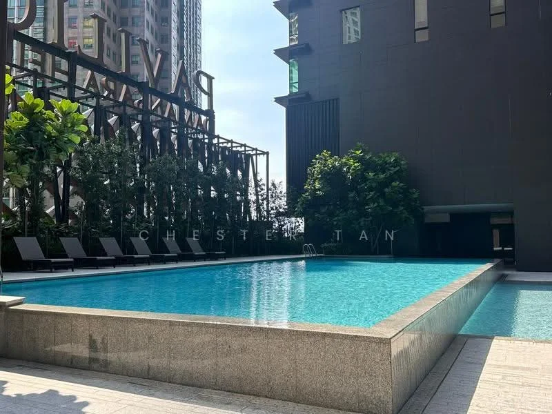 Exterior type: high-rise condominium; features: infinity pool, pool deck with loungers, landscaped greenery, glass curtain wall, modern architecture, surrounded by high-rise buildings, sunny outdoor area; style: modern.