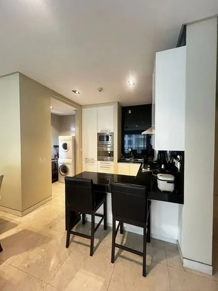Kitchen features: white cabinetry, black granite countertop, stainless-steel built-in oven, stainless-steel microwave, stainless-steel range hood, 4-burner gas hob, single-bowl stainless-steel sink, chrome pull-down faucet, tile backsplash, pendant lighting, bar seating with 2 stools, cream painted walls, marble tile flooring; style: modern. Laundry features: stacked front-load washing machine, stacked dryer.