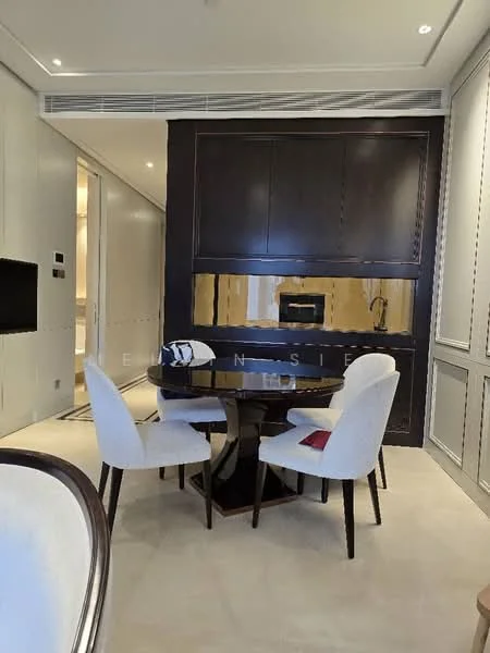Dining features: round dining table, 4 dining chairs with upholstered seats, dark wood table base, light-colored flooring, wall-mounted cabinetry, built-in microwave, recessed lighting, neutral wall color, decorative wall paneling; style: modern.