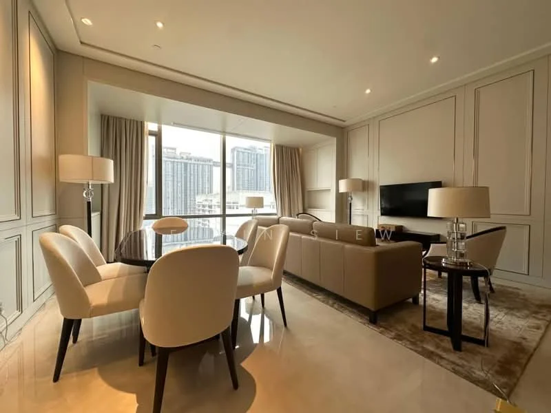 Living features: cream painted walls, marble flooring, floor-to-ceiling windows, curtains, chandelier, 3-seater fabric sofa in beige, 2-seater fabric sofa in beige, round dining table, 4 upholstered dining chairs, TV console, wall-mounted TV, area rug with geometric pattern, decorative mirror; style: modern; view: city.