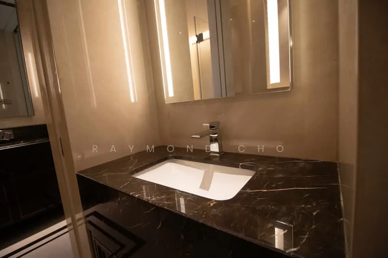 Bathroom features: single-bowl sink, chrome faucet, black marble countertop, backlit mirror, wall-mounted lighting, cream painted walls, dark cabinetry, tile flooring; style: modern.