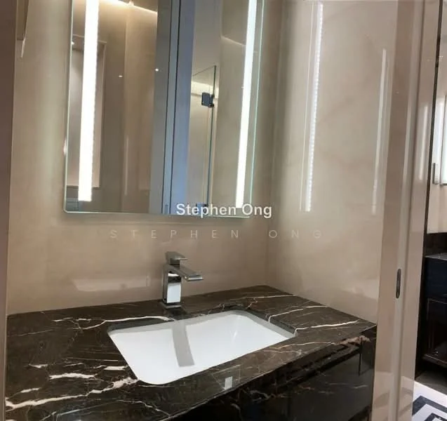 Bathroom features: single-bowl sink, chrome basin mixer faucet, black marble countertop, lighted mirror, cream marble walls, recessed lighting, dark cabinetry; style: modern.