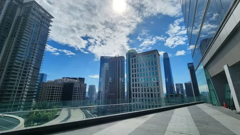 Exterior type: high-rise condominium; features: glass facade, outdoor terrace, city skyline view, paved flooring, surrounded by skyscrapers, clear blue sky, sunlight reflection on glass, green landscaping below; style: modern.