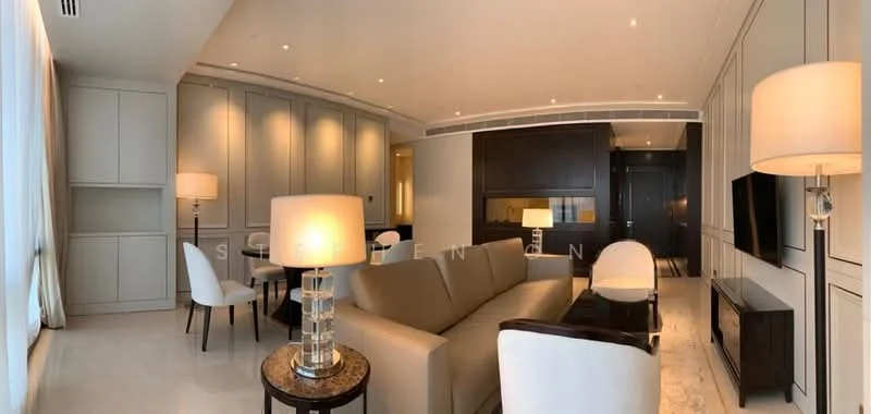 Living features: cream painted walls, marble flooring, recessed downlights, sofa in beige, coffee table with round top, 2 white upholstered armchairs, wall-mounted TV, built-in cabinetry, decorative wall paneling, floor-to-ceiling windows with sheer curtains, side table with lamp; style: modern.