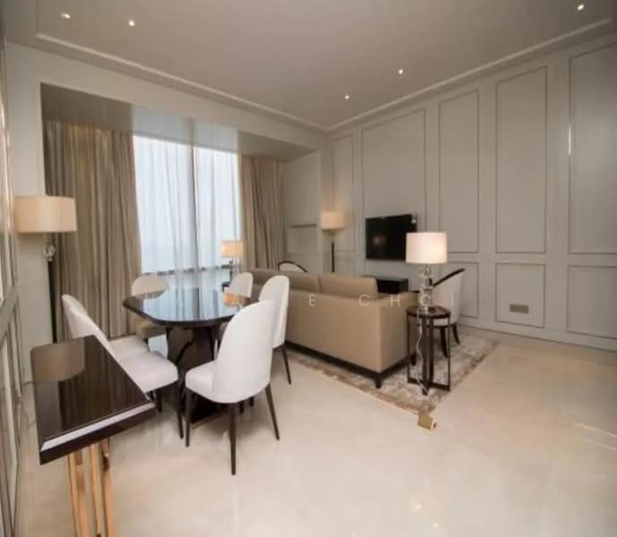 Living features: cream painted walls, white ceiling with crown moulding, marble flooring, floor-to-ceiling windows with sheer curtains, 3-seater beige sofa, 2 white upholstered dining chairs, round dining table, 2 table lamps with beige shades, TV console, wall-mounted TV, area rug with neutral tones; style: modern; view: city.