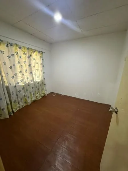 Room features: white painted walls, wooden flooring, window with sheer curtains, ceiling light fixture, no visible furniture.