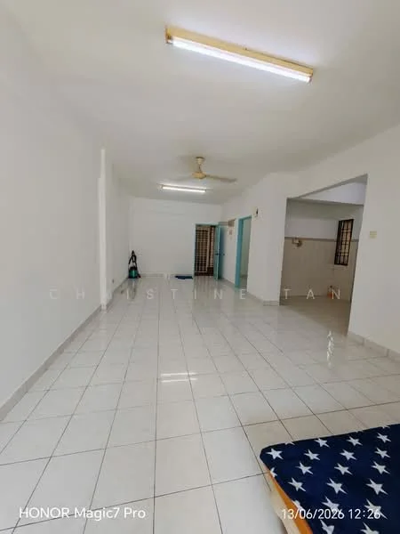 Room features: white painted walls, glossy white floor tiles, ceiling with fluorescent lighting, ceiling fan, open layout, vacuum cleaner visible, blue mattress on the floor, doorway leading to another room; style: minimalist.