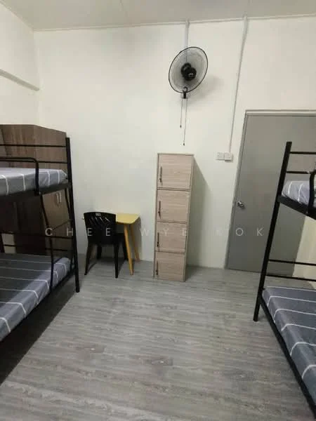 Bedroom features: bunk beds with grey bedding, wooden wardrobe, small yellow side table, black chair, wall-mounted ceiling fan, light grey laminate flooring, white painted walls, door to hallway.