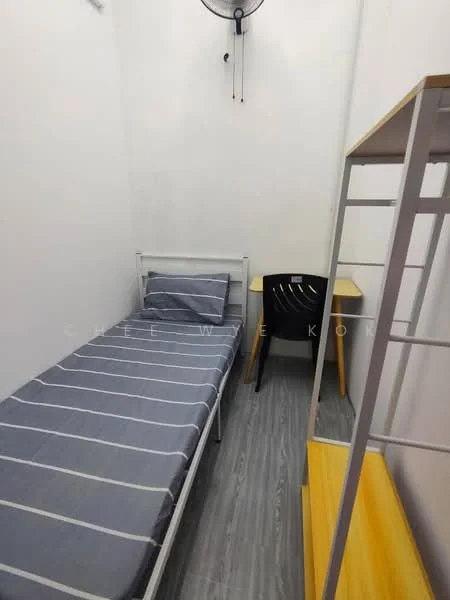 Bedroom features: single bed with grey striped bedding, white metal bed frame, wooden study desk in yellow, black chair, light grey laminate flooring, white painted walls, wall-mounted ceiling fan; style: minimalist.