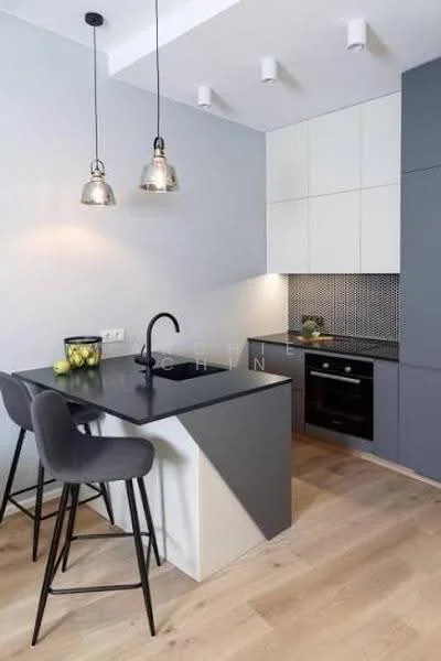 Kitchen features: grey cabinetry, white upper cabinets, black countertop, grey backsplash with mosaic pattern, built-in oven, stainless-steel sink, chrome pull-down faucet, 2 pendant lights, bar stools, wood flooring, recessed downlights; style: modern.