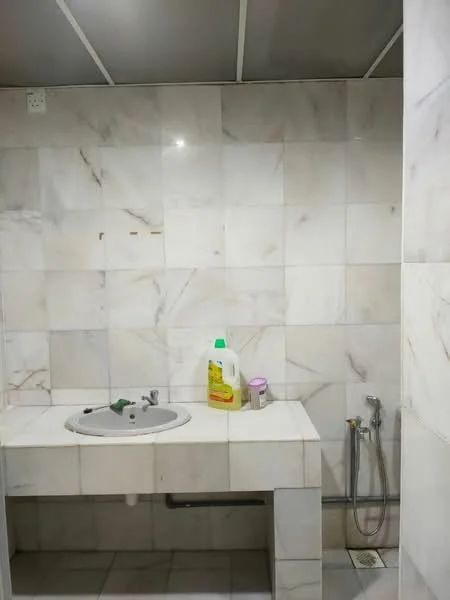 Bathroom features: white marble tile walls, white marble tile flooring, single-bowl sink, chrome faucet, handheld shower, cleaning supplies on countertop, wall-mounted mirror, exposed plumbing, ceiling with panels; style: modern.