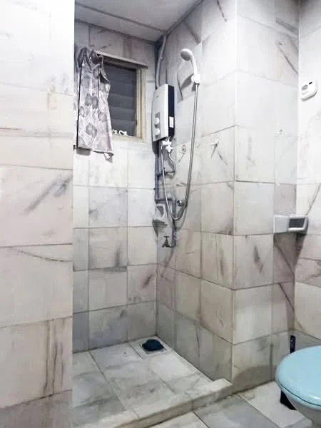 Bathroom features: marble tile walls, marble tile flooring, shower area with glass partition, handheld shower head, wall-mounted shower mixer, toilet, curtain for window, built-in soap holder; style: modern.