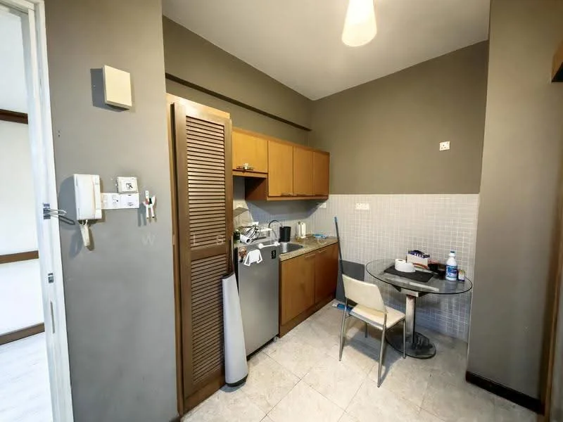 Kitchen features: brown wooden cabinetry, stainless-steel fridge, built-in oven, stainless-steel sink, chrome pull-down faucet, white tiled backsplash, round dining table, single dining chair, light fixture, grey painted walls, ceramic tile flooring; style: modern.