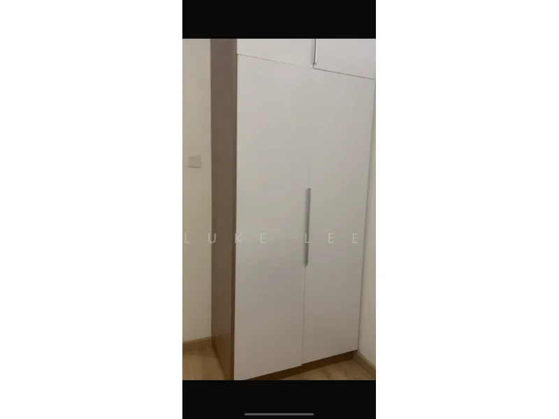 Room features: white cabinetry, wood trim, two-door cabinet, minimalist design, handle-less doors, built-in storage, light wood flooring, neutral wall color; style: modern.