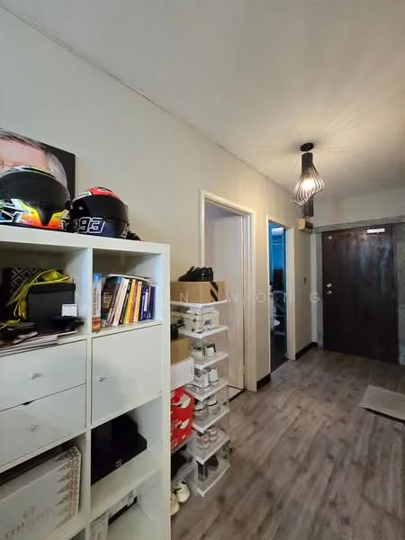 Room features: wooden flooring, white painted walls, pendant light fixture, shoe storage rack, open shelving unit, decorative wall art, doorway leading to other rooms, carpet mat at entrance; style: modern.