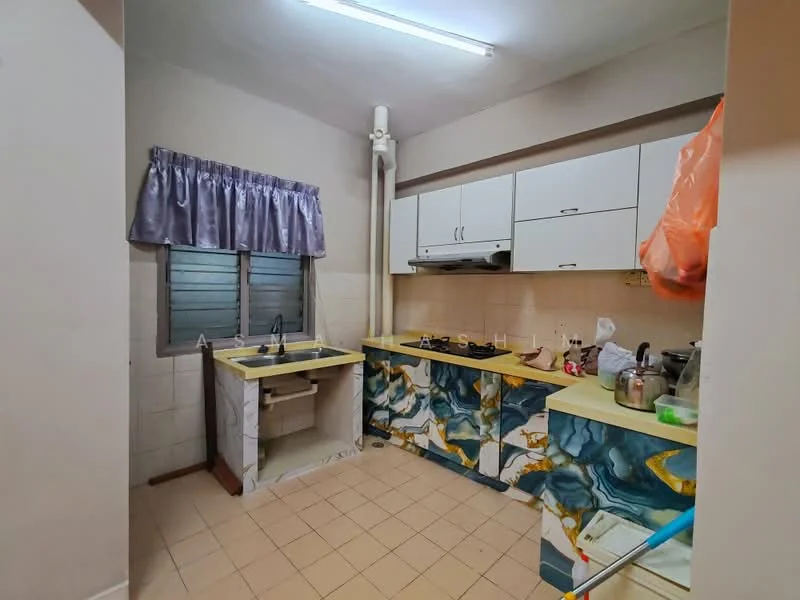 Kitchen features: yellow laminate countertop, single-bowl sink, chrome faucet, white upper cabinets, decorative blue and gold patterned lower cabinets, built-in gas stove, exhaust hood, window with metal grilles, tile flooring, curtains, wall-mounted pipe, kitchen utensils on countertop.