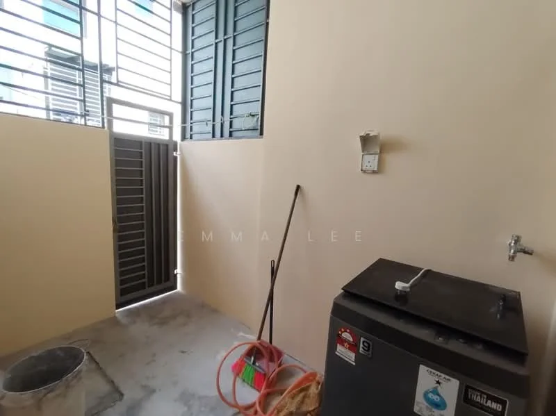 Room features: grey concrete flooring, cream painted walls, metal window grilles, single-basin sink, outdoor access door, water hose, cleaning tools, wall-mounted electrical outlet.