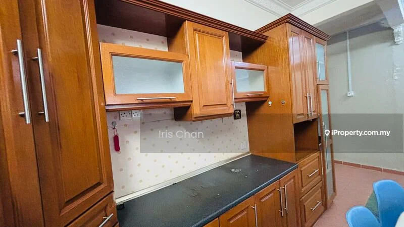 Kitchen features: wooden cabinetry, black countertop, glass-front upper cabinets, built-in shelving, wall-mounted electrical outlets, polka dot wallpaper, kitchen sink area, drawer storage; style: traditional.