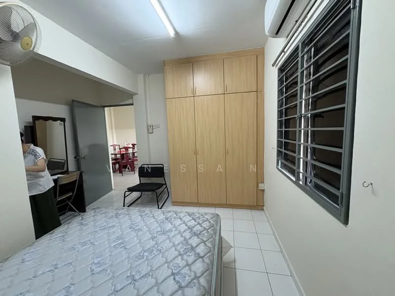 Bedroom features: single bed, mattress on bed frame, built-in wardrobe with wooden finish, white tiled flooring, air conditioning unit on wall, window with metal grille, ceiling fan, study desk, chair.