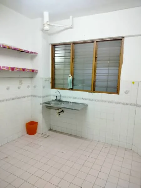 Laundry features: single-bowl stainless-steel sink, chrome faucet, white tiled walls, pink tiled backsplash, light pink floor tiles, wooden window with horizontal slats, open shelving on wall, orange plastic waste bin.