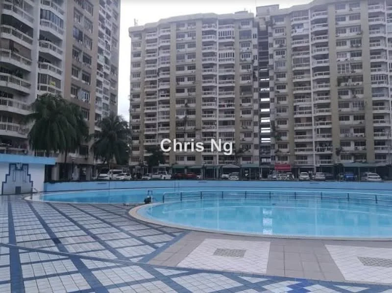 Exterior type: high-rise condominium; features: swimming pool, pool deck with tiled flooring, surrounding high-rise buildings, landscaped area with palm trees, multiple parking spaces visible, balconies on residential units, glass railings around the pool area; style: modern.