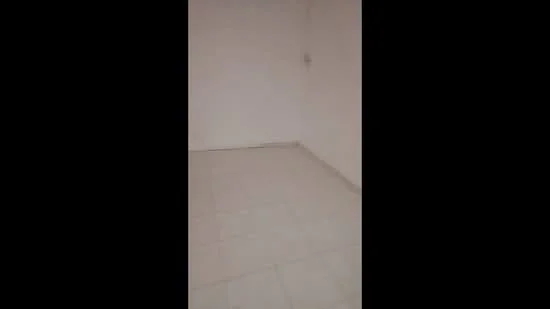 Room features: white painted walls, tile flooring, empty space.