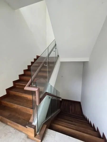 Staircase features: wooden staircase, glass railing, white painted walls, tile flooring, natural light from upper level; style: modern.