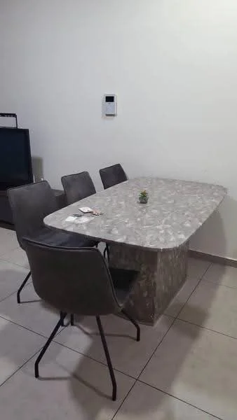 Dining features: rectangular dining table with grey marble top, 4 grey upholstered dining chairs, tile flooring, white painted walls, wall-mounted thermostat, small decorative plant on table; style: modern.