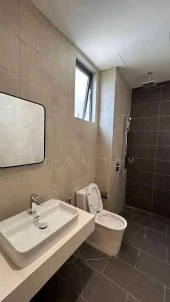 Bathroom features: grey tiled walls, light beige tiled walls, square mirror with black frame, single-bowl ceramic sink, chrome basin mixer faucet, one-piece toilet, shower with wall-mounted rain shower head, sliding glass shower door, dark grey floor tiles, window for natural light; style: modern.