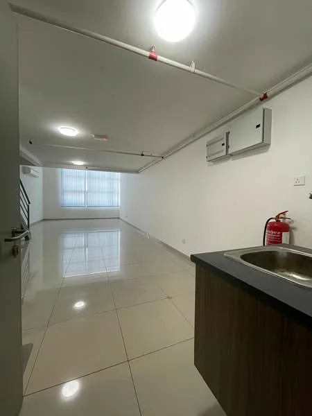Room features: white painted walls, glossy ceramic tile flooring, recessed ceiling lights, fire extinguisher mounted on wall, window with vertical blinds, exposed ceiling pipes, single-bowl stainless-steel sink, wood cabinetry under sink, open layout, neutral color scheme; style: modern.