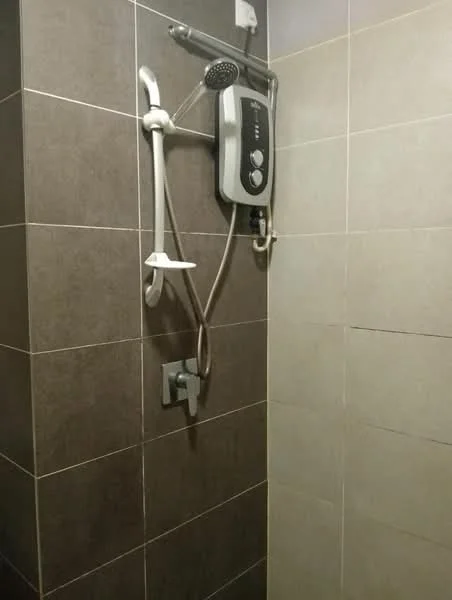 Bathroom features: shower area, wall-mounted showerhead, handheld shower, chrome faucet, tiled walls in light and dark shades, built-in soap holder, shower control panel, non-slip floor tiles; style: modern.