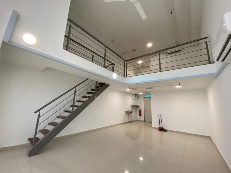 Room features: open layout, staircase with wooden steps and metal railing, white painted walls, polished tile flooring, ceiling fan, wall-mounted air conditioning unit, recessed lighting, kitchenette area with sink, fire extinguisher mounted on wall; style: modern.