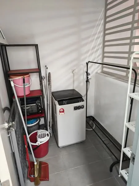 Laundry features: top-load washing machine, grey tiled flooring, metal shelving unit, plastic storage bins in red and pink, cleaning supplies, clothes drying rack, slatted window for ventilation, mop and broom, laundry basket.