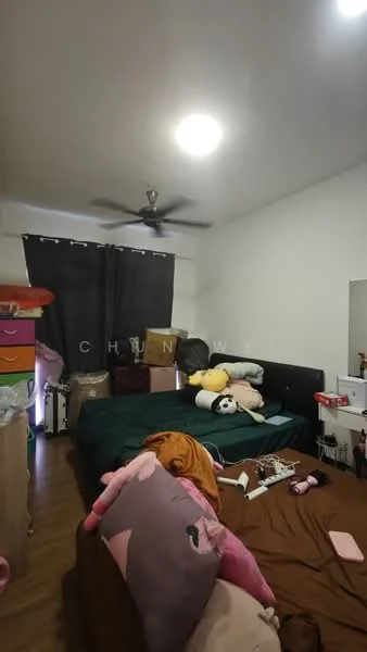 Bedroom features: two beds with brown and green bedding, black upholstered headboard, ceiling fan, wooden flooring, dark curtains, colorful storage drawers, stuffed animals on beds, decorative pillows, nightstand with items.