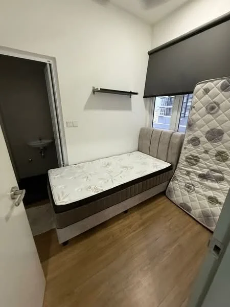 Bedroom features: single bed with mattress, upholstered headboard, wooden flooring, white painted walls, blackout roller blinds, shelf on wall, door leading to bathroom, small sink visible in bathroom, light fixture on ceiling; style: modern.