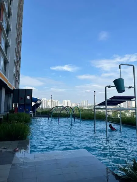 Exterior type: high-rise condominium; features: infinity pool, pool deck with loungers, children's playground, water slide, landscaped garden, surrounding city skyline, sunshade structures; style: modern.