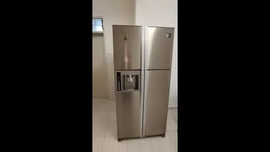 Room features: stainless-steel side-by-side fridge, water dispenser, ice maker, two doors, silver finish.