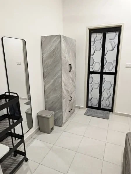 Room features: grey marble-patterned cabinet, black handles on cabinet, white walls, light grey tiled flooring, black metal shelving unit, small grey trash bin, black-framed glass door with geometric pattern, grey doormat; style: modern.